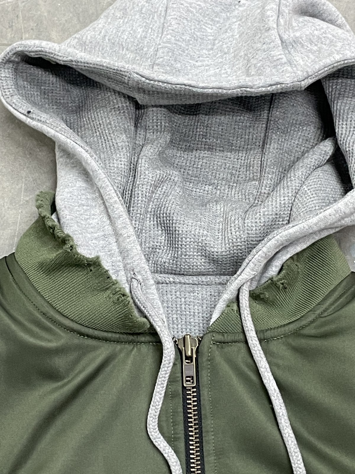 Olive bomber jacket hood and zipper detail