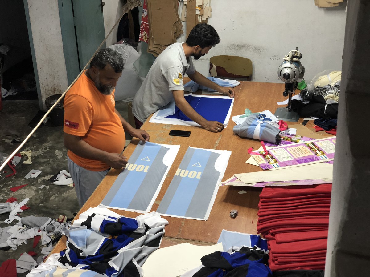 Workers matching sublimated jersey pattern pieces before stitching