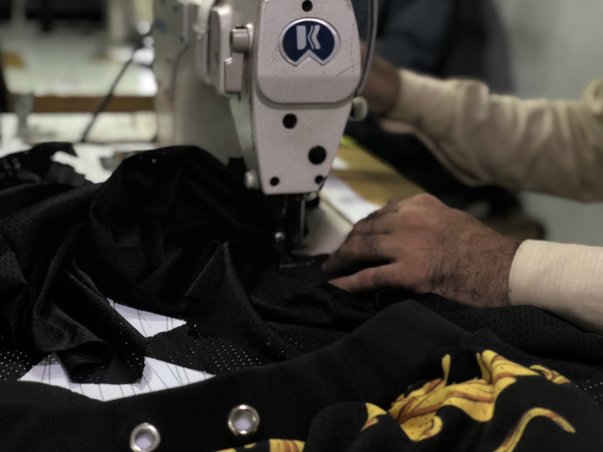 Close-up of a machinist stitching a mesh jersey