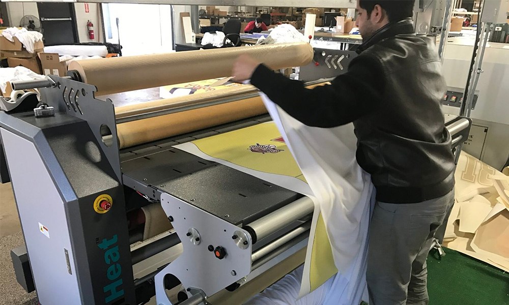 Heat transfer press applying graphics to a jersey