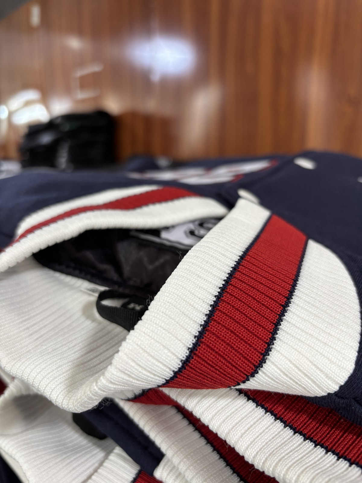 Navy varsity jacket with ribbed cuffs, detail